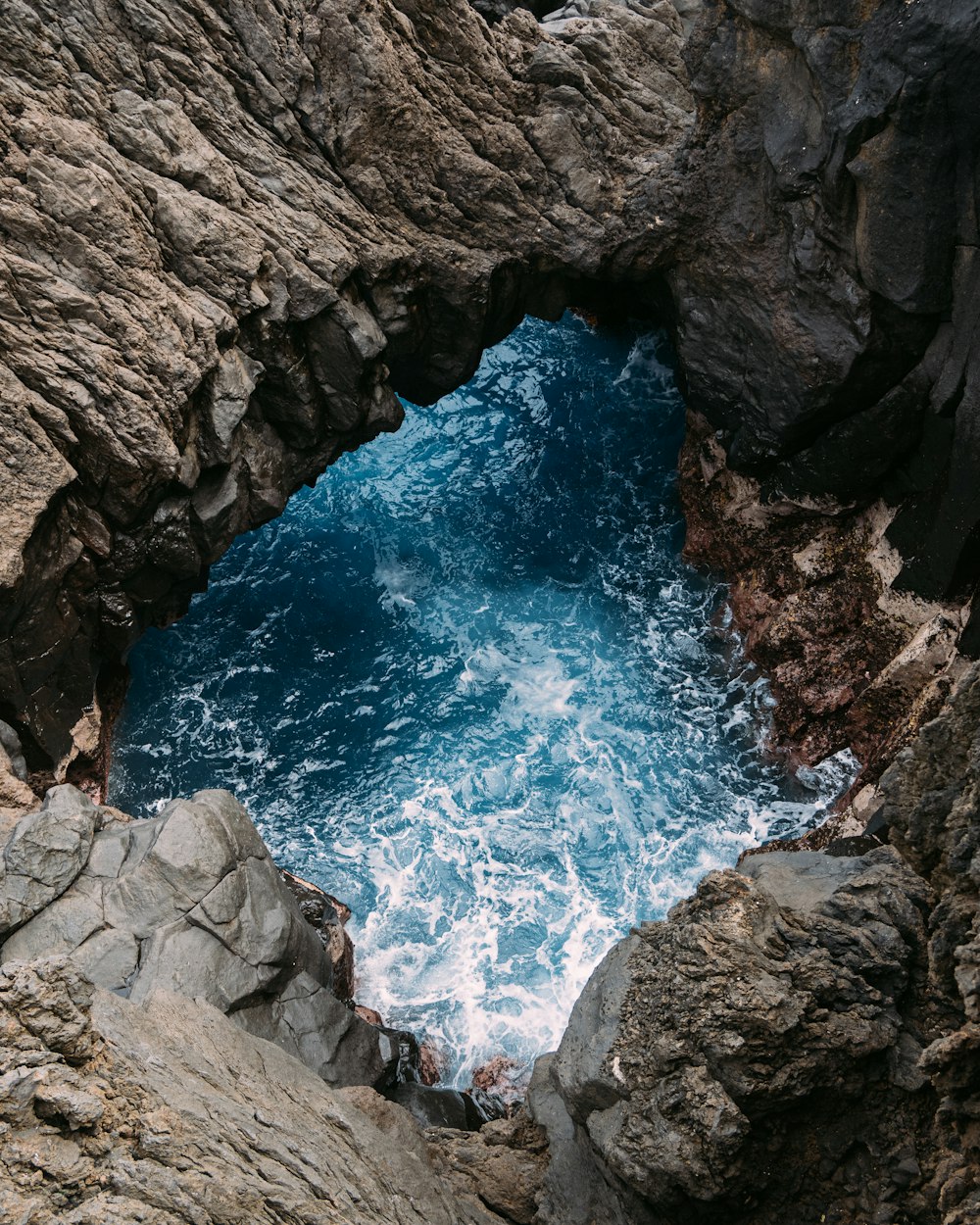 a view of a body of water through a cave