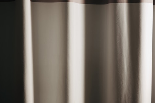 Custom-made curtains in beige and brown tones complementing majlis