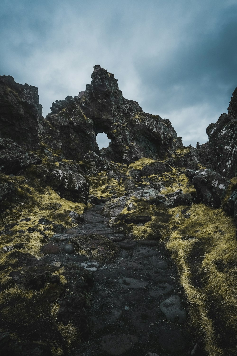 a rocky path with moss growing on it