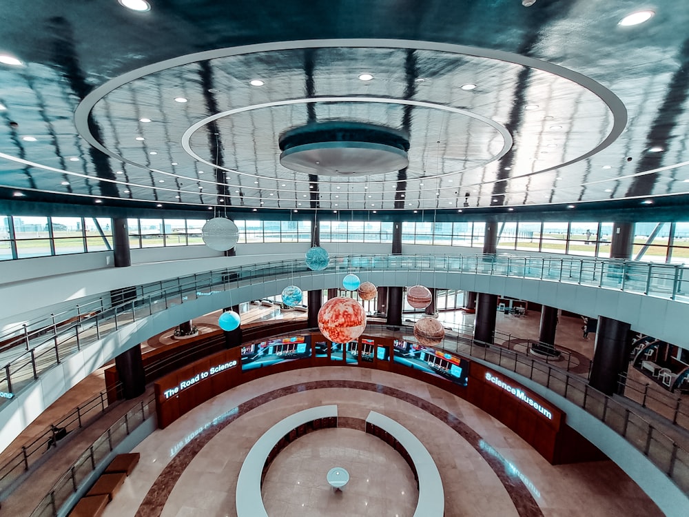 a large circular building with a clock on the ceiling