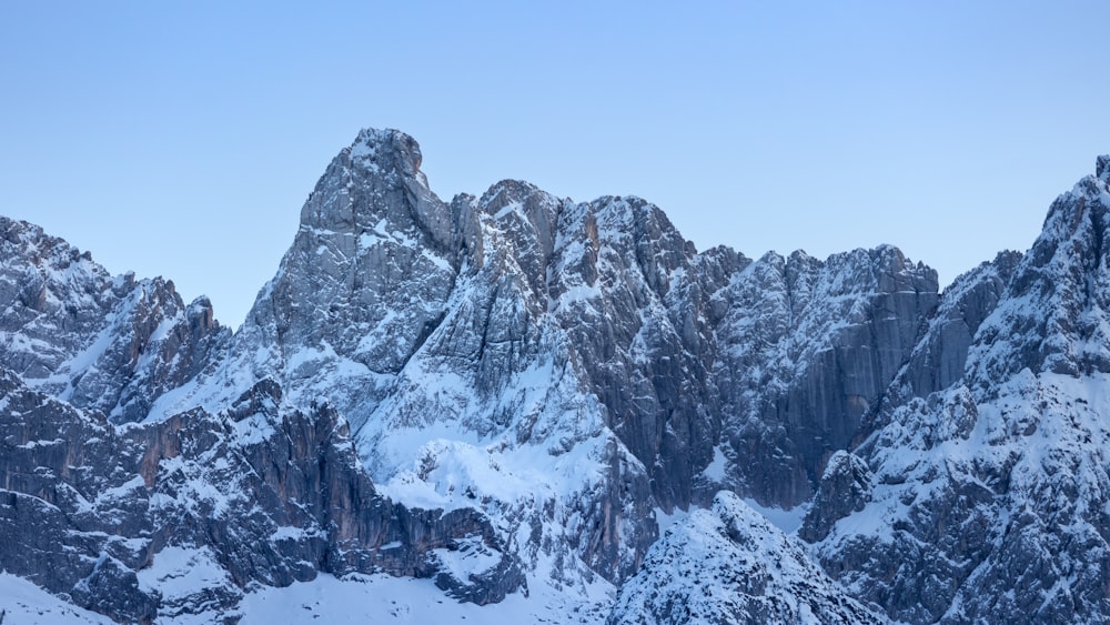 a mountain range covered in snow in the winter