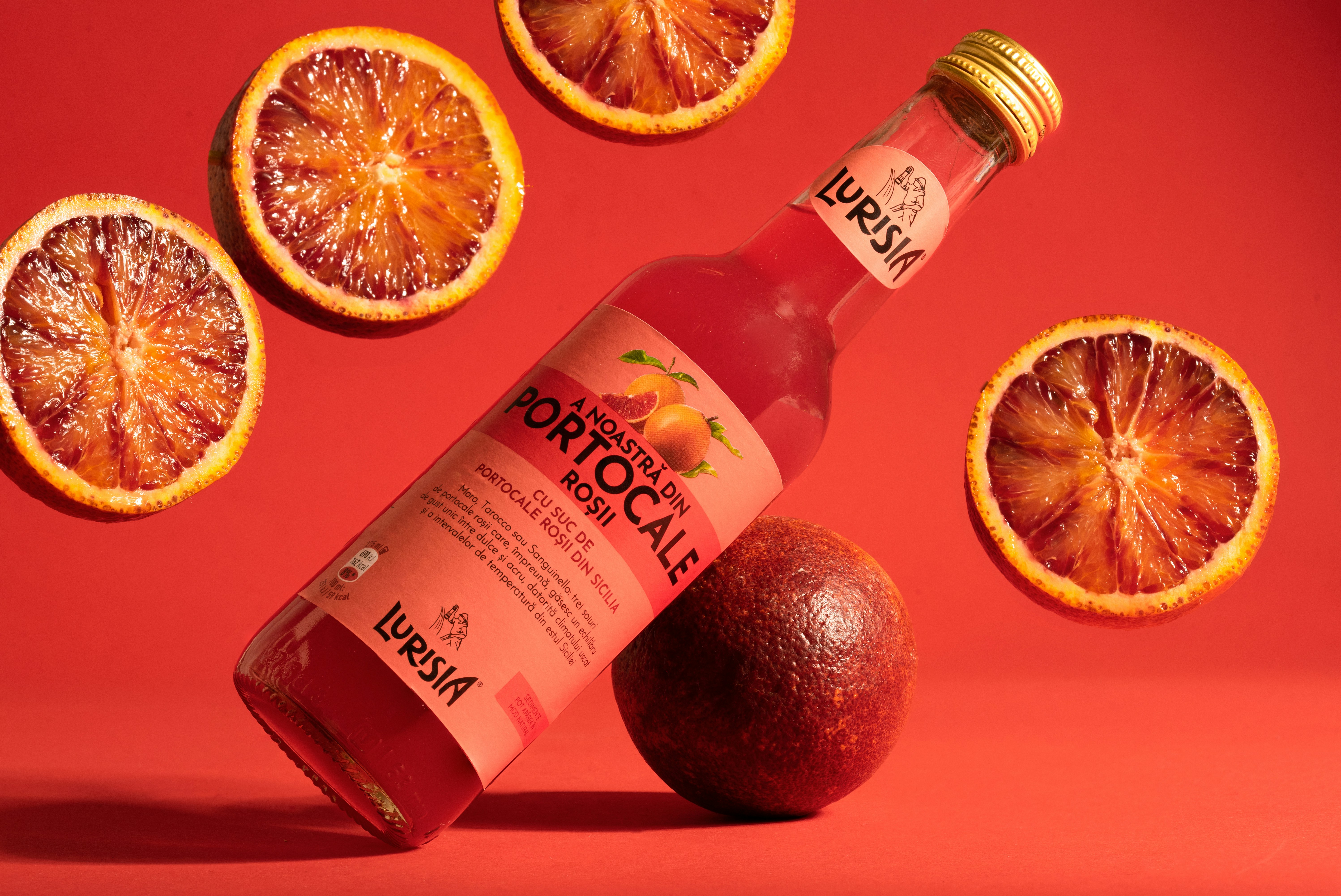 A bottle of blood orange juice surrounded by blood oranges photo Free Romania Image on Unsplash