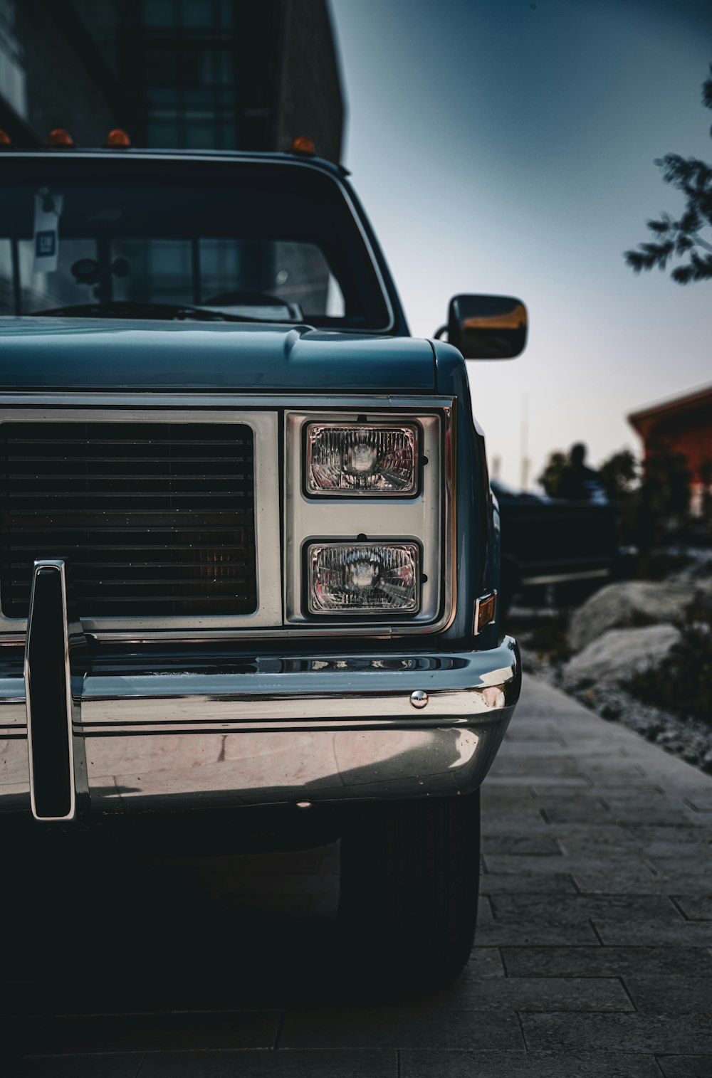 the front end of a truck parked on a sidewalk