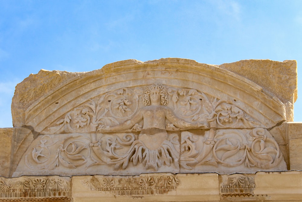 a close up of a stone carving on a building