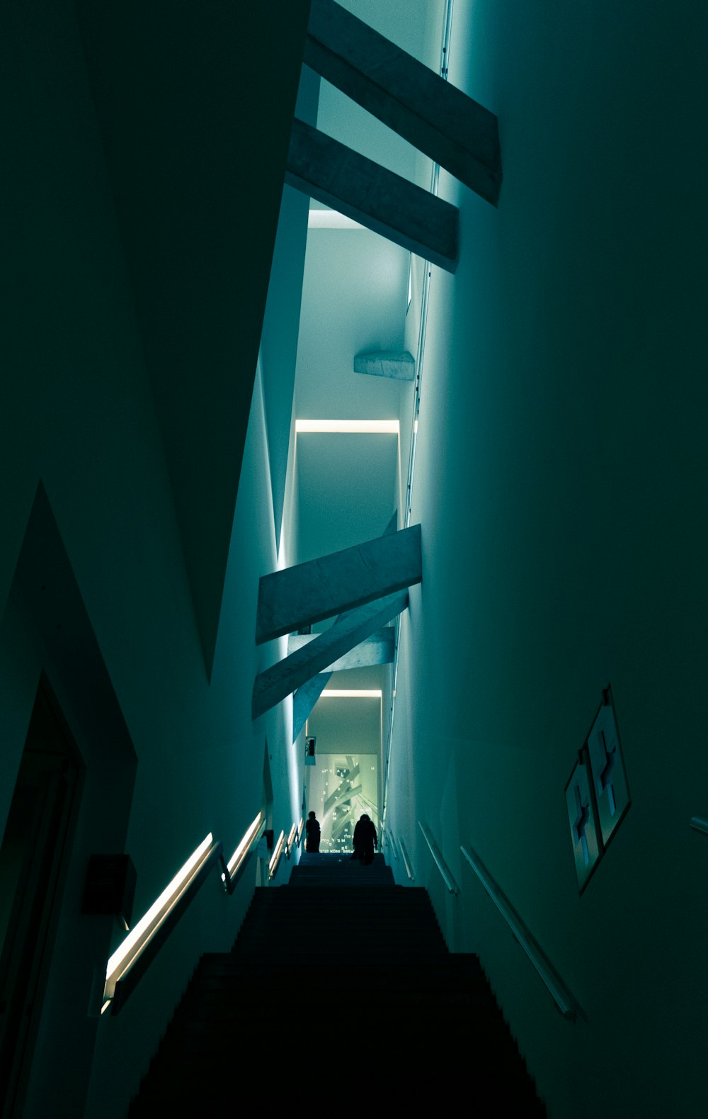 a long hallway with stairs leading up to a light