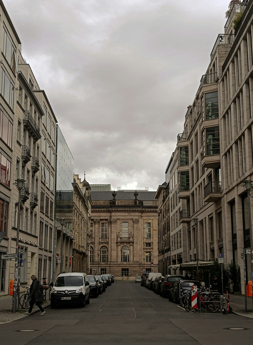 a city street lined with tall buildings and parked cars