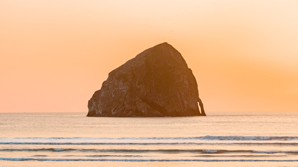 a large rock sticking out of the ocean