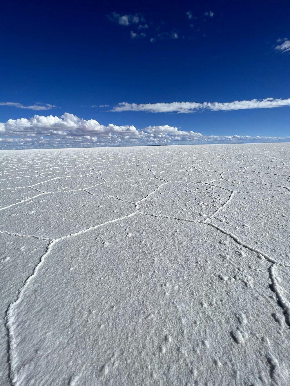 a vast expanse of white snow under a blue sky