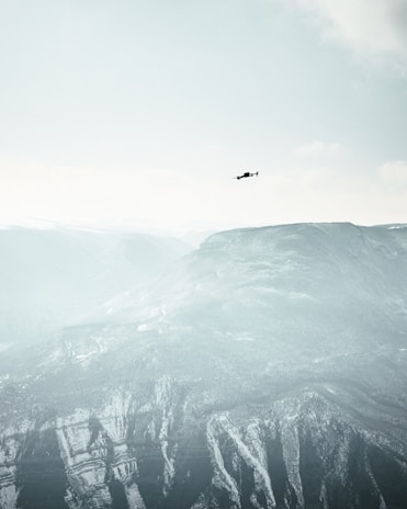 High-altitude mother drone cruising silently at 18 kilometers, with a backdrop of a clear blue sky.