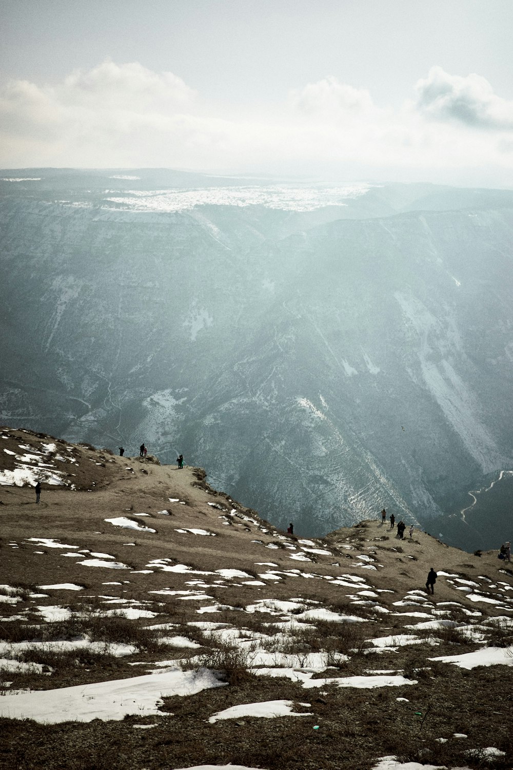 a group of people standing on top of a snow covered slope