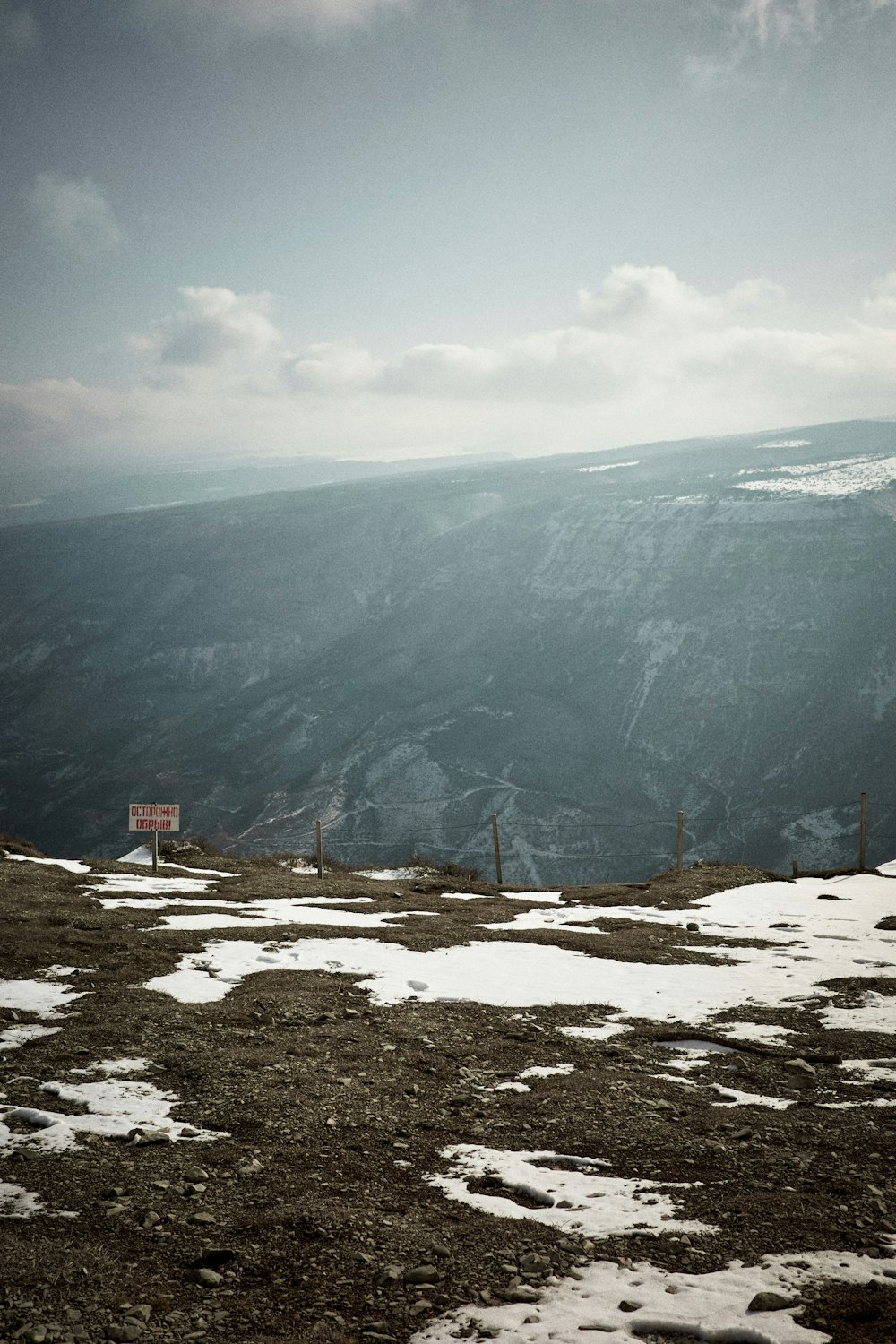 a view of a mountain with snow on the ground