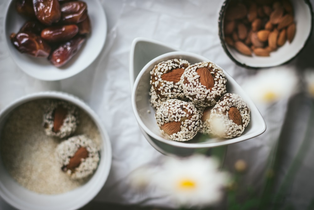 a table topped with bowls of food and nuts