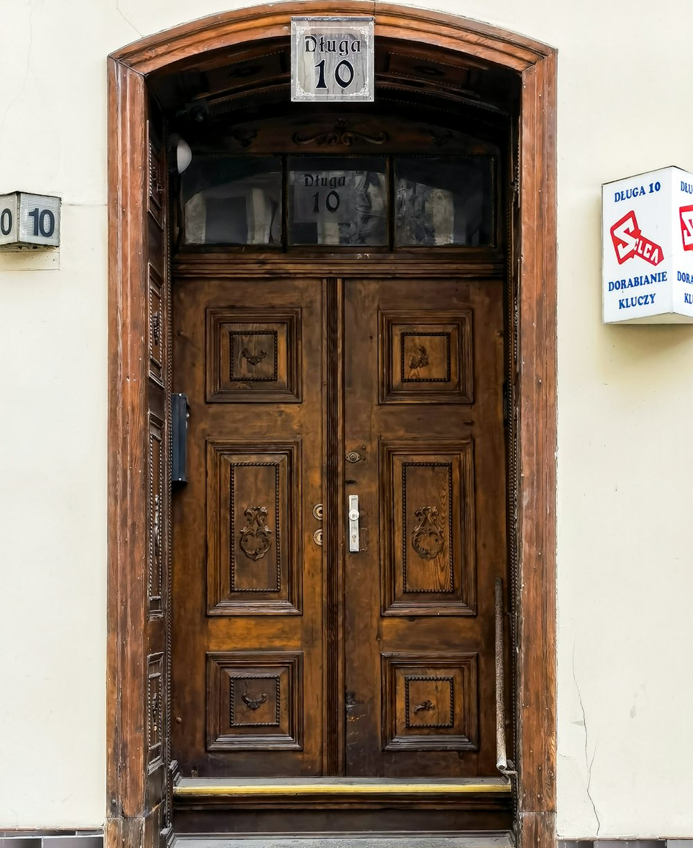 a wooden door with a sign on the side of it