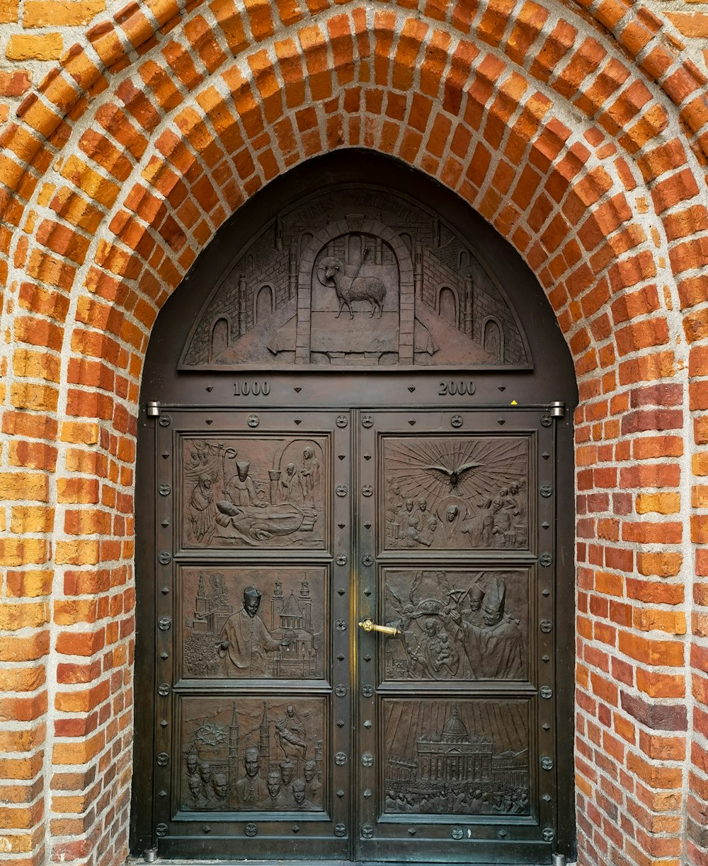 a close up of a metal door on a brick building