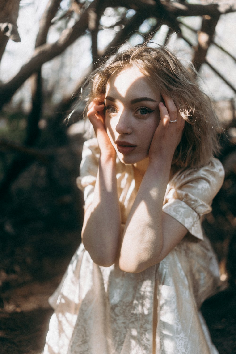 a woman in a white dress posing for a picture