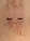 False eyelashes are laid on a sandy surface dusted with specks of brown and white powder.