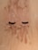 False eyelashes are laid on a sandy surface dusted with specks of brown and white powder.