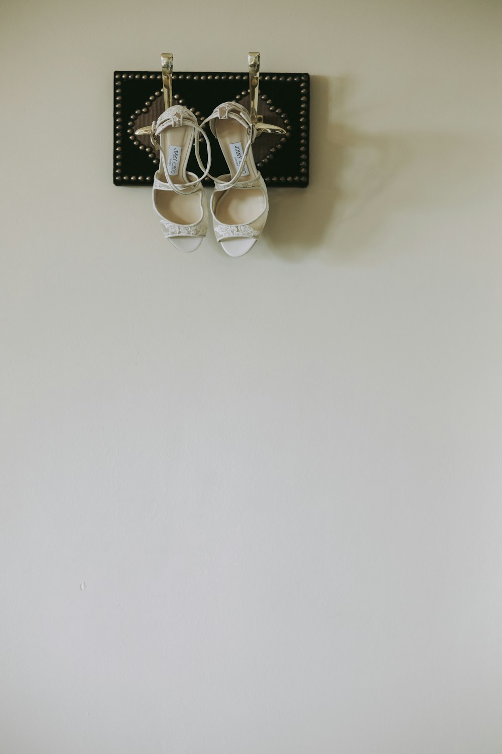 a pair of white shoes hanging on a wall