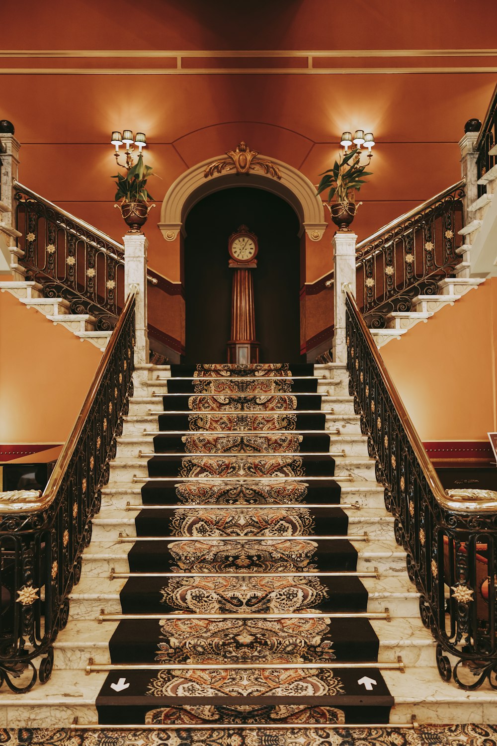 a staircase leading up to a clock on the wall