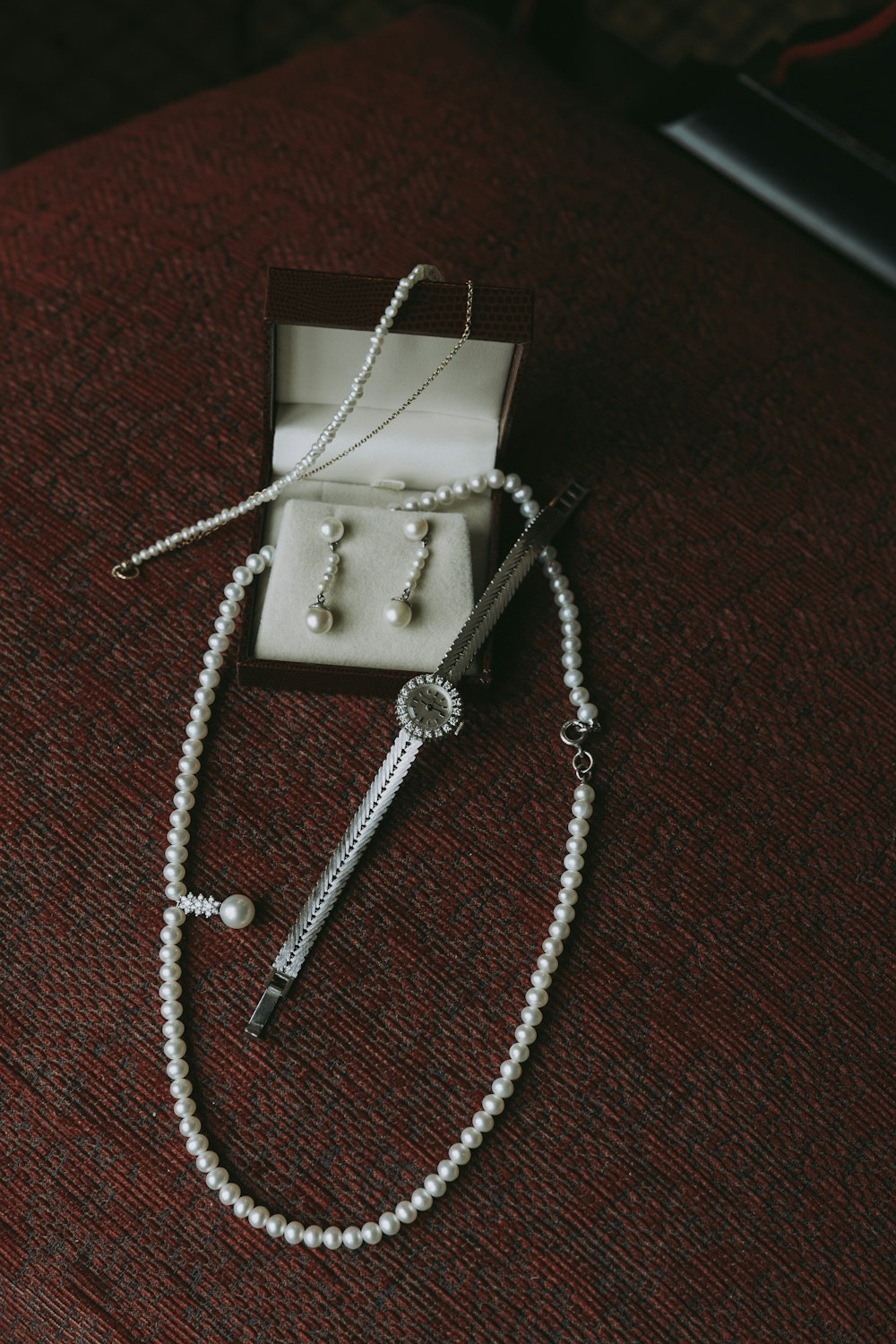 a pearl necklace and a pair of scissors