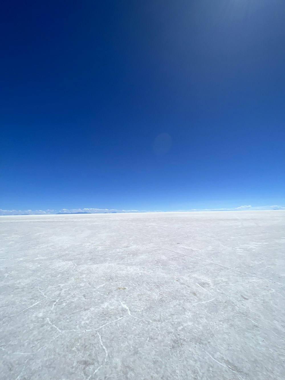 a vast expanse of ice under a bright blue sky
