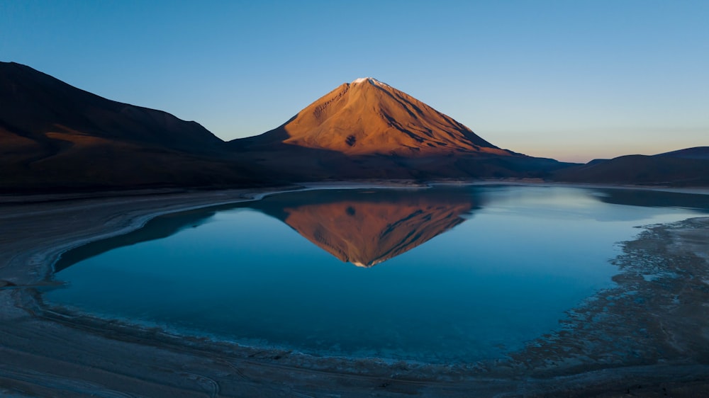 a mountain with a lake in front of it