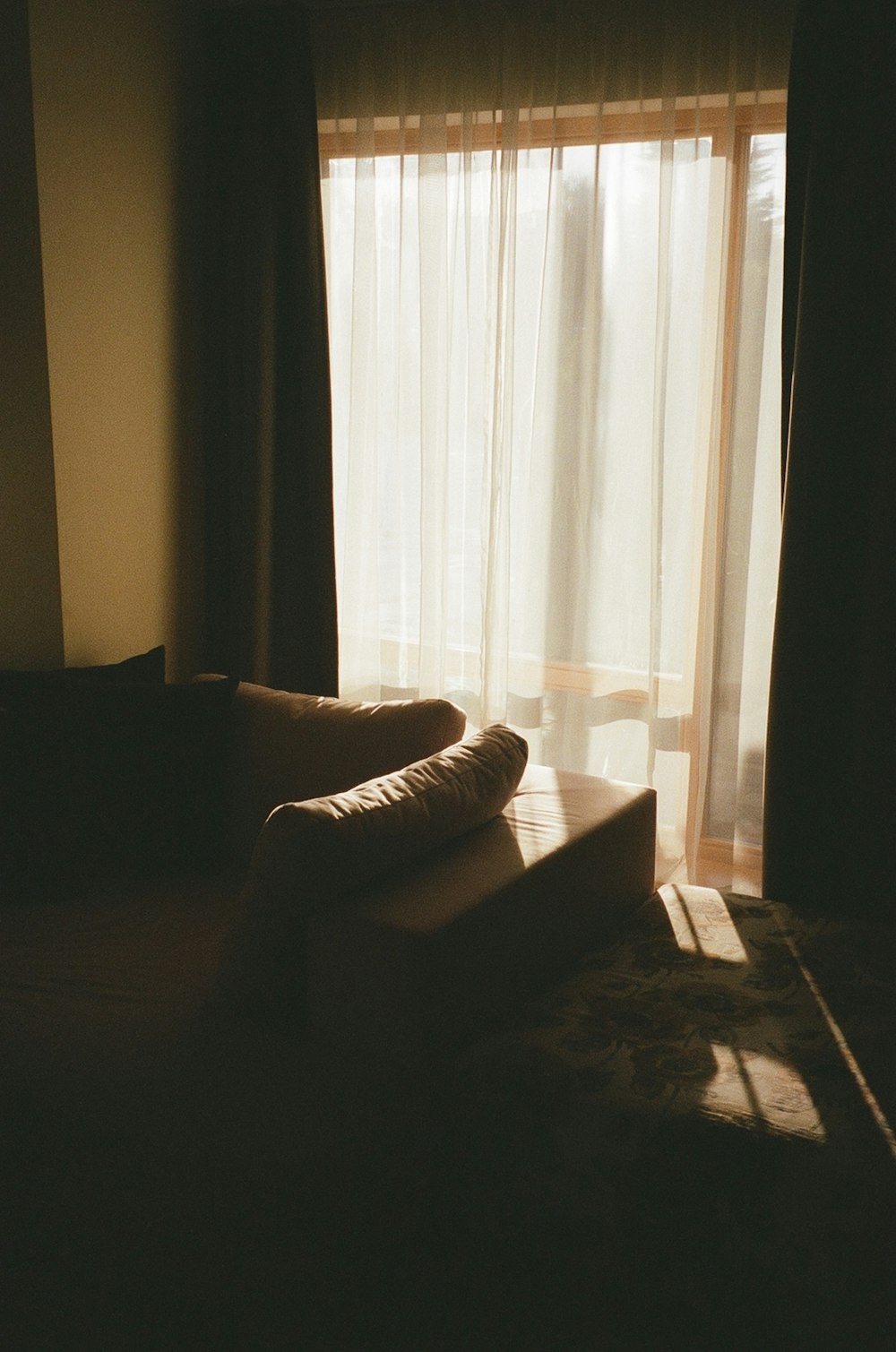 a couch sitting in front of a window in a living room