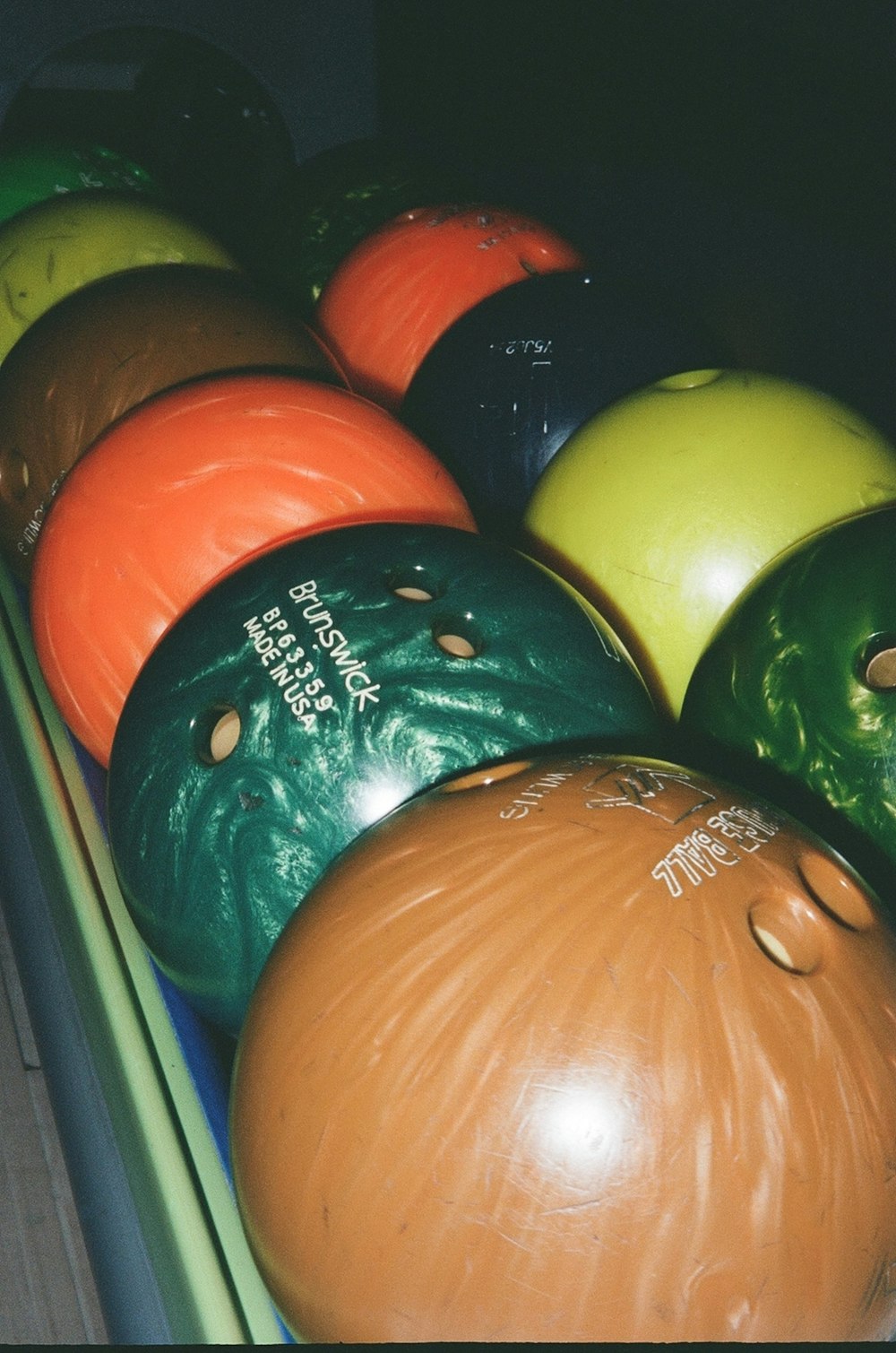 a bunch of bowling balls sitting on top of each other