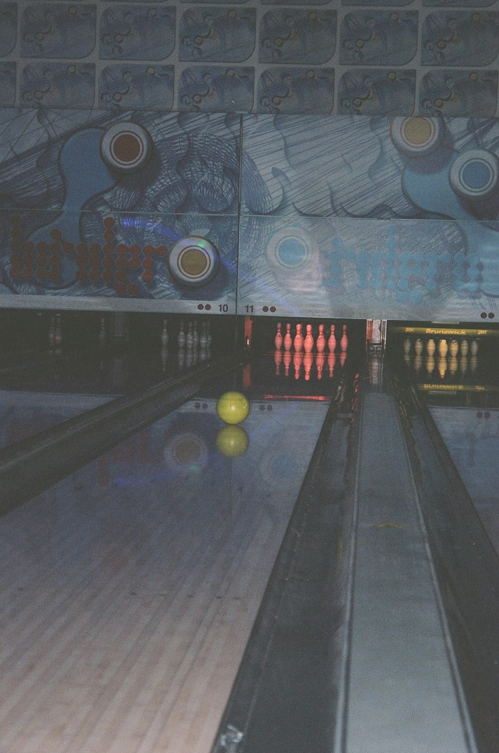 a bowling alley with bowling balls in the lanes