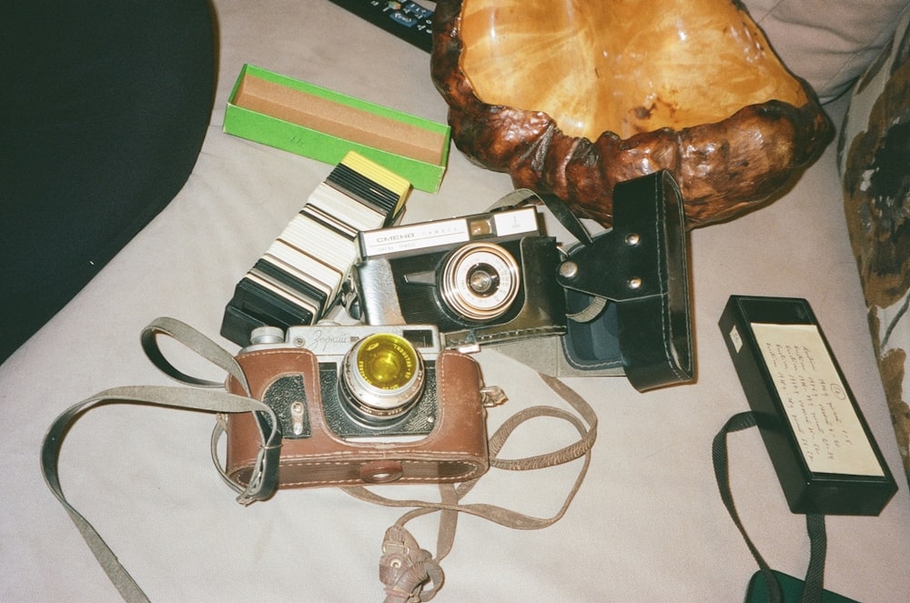 a table topped with a camera and other items