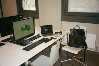 A modern office desk with a global map and communication devices.