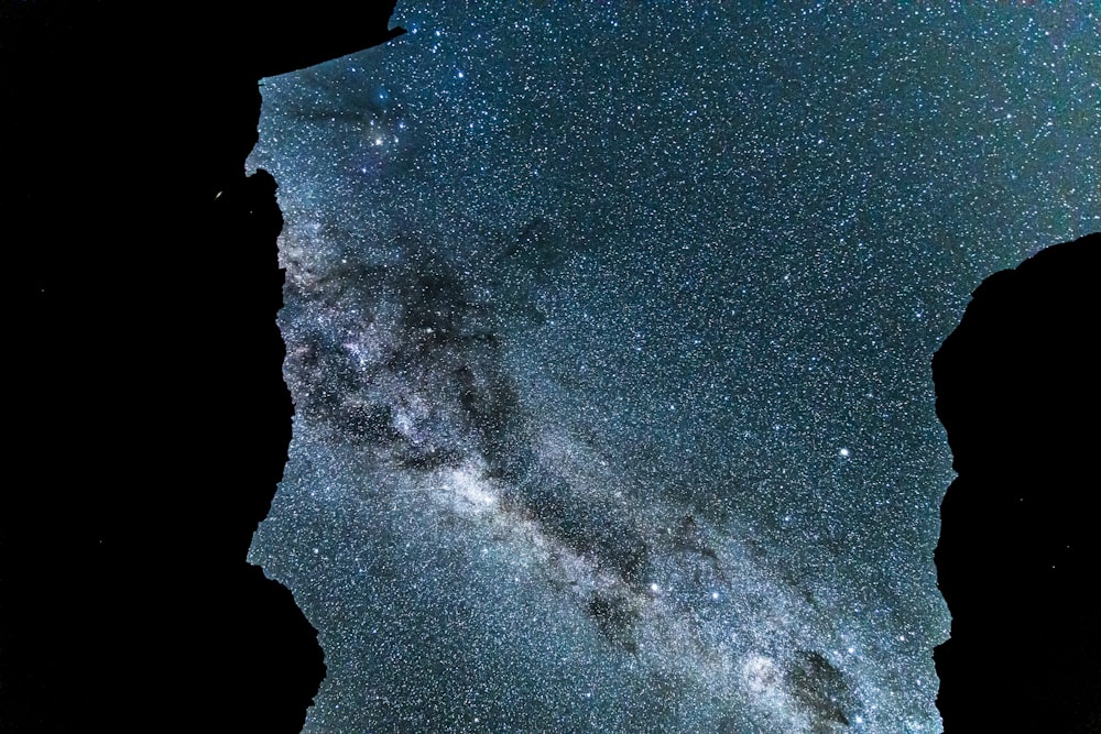 a view of the night sky from the top of a mountain