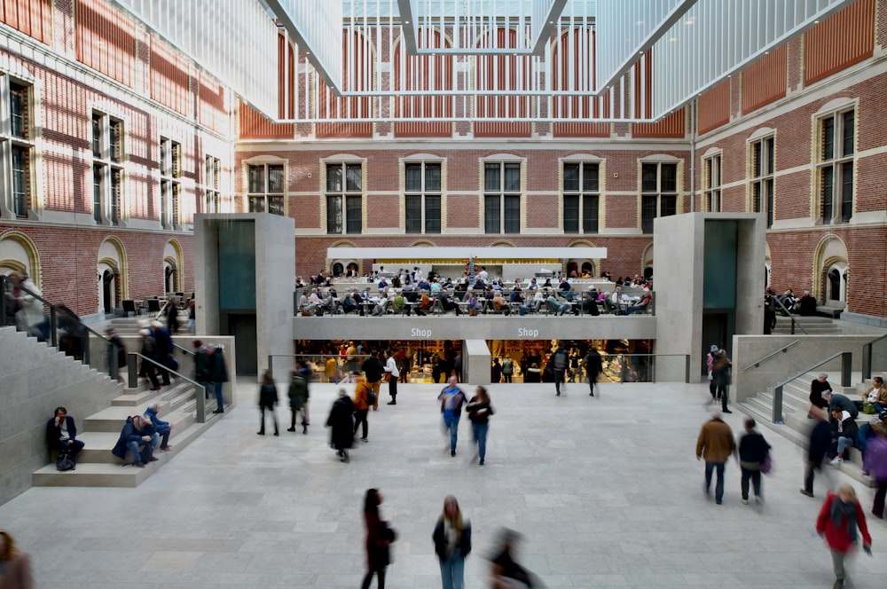 a group of people walking around a building