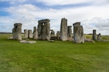 a group of stonehenges in a grassy field