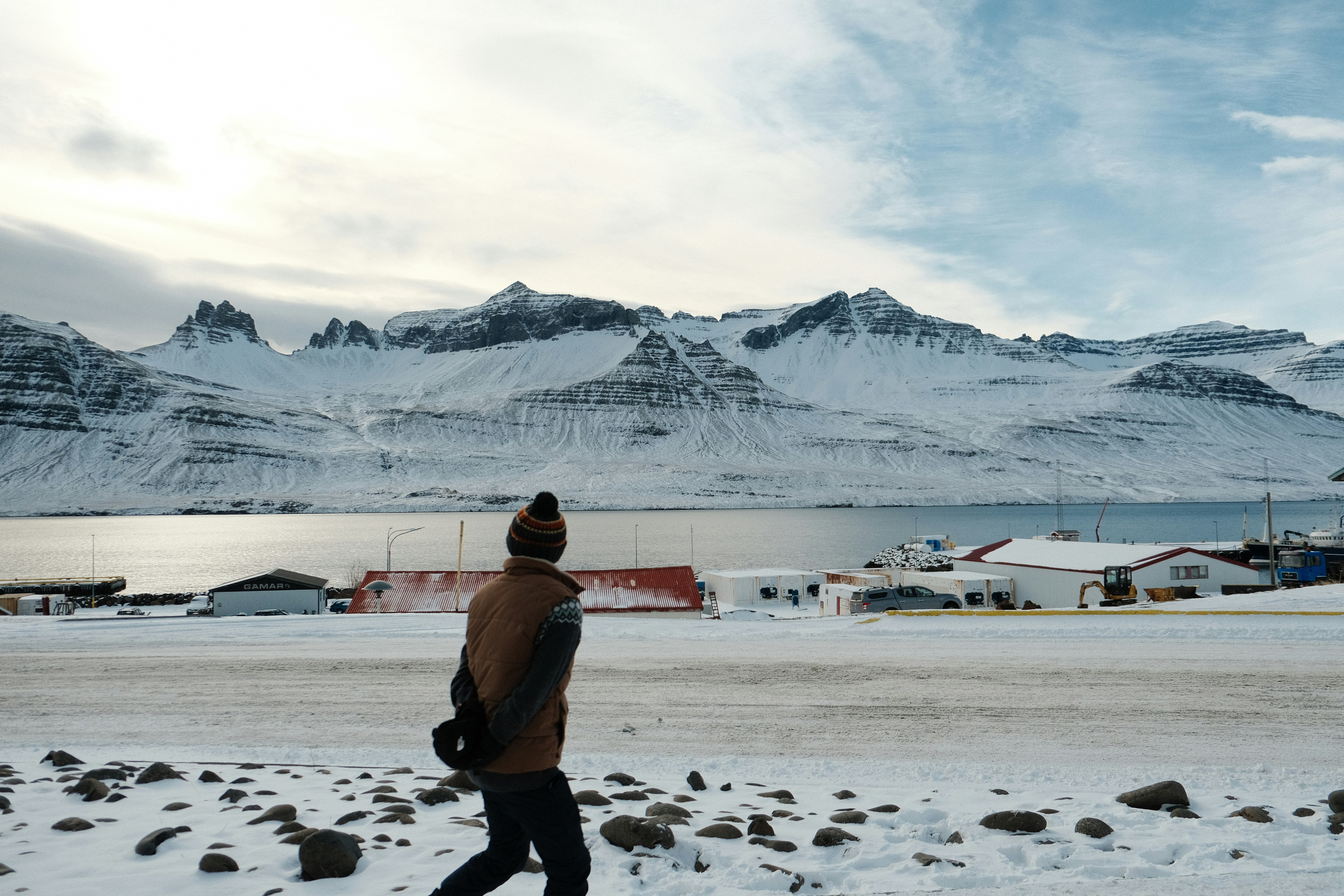 a man walking across a snow covered field