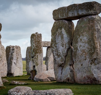 a group of stonehenges in a grassy field