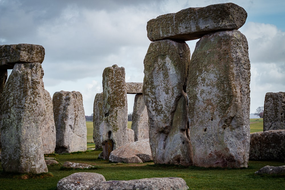 a group of stonehenges in a grassy field