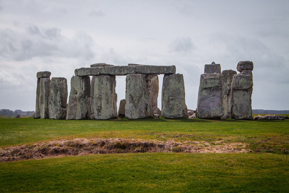 a stonehenge monument in a grassy field