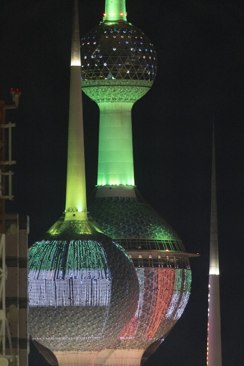 a very tall building with a very colorful light on it's side