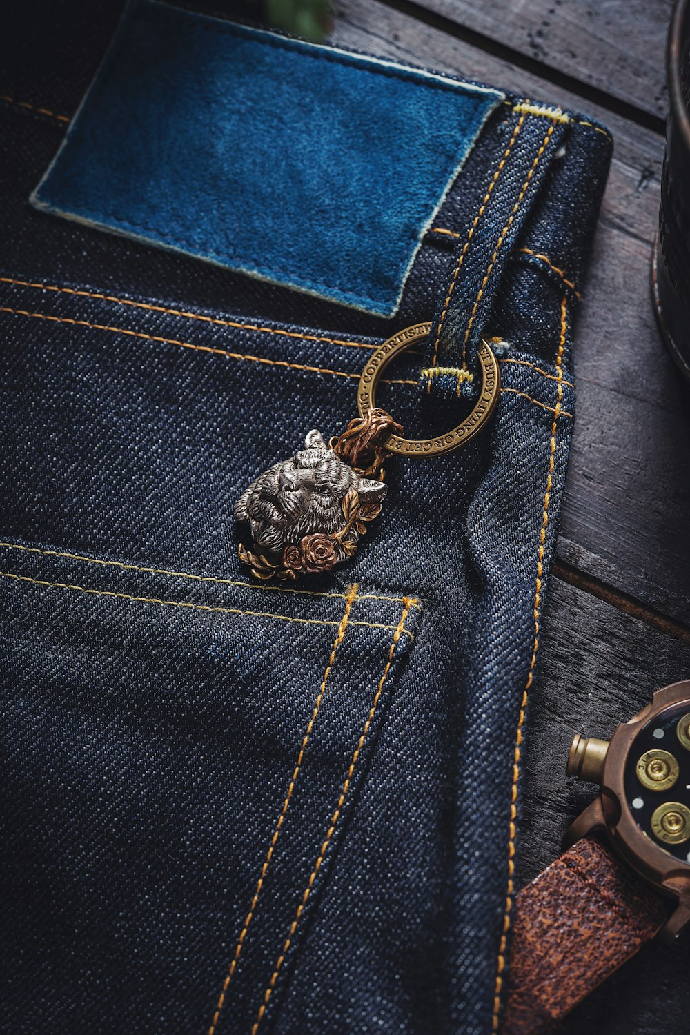 A pocket watch sitting on top of a pair of jeans photo – Free Pants Image  on Unsplash