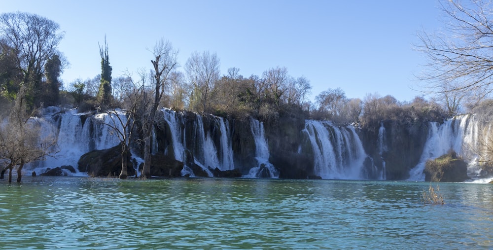 a body of water with a waterfall in the background