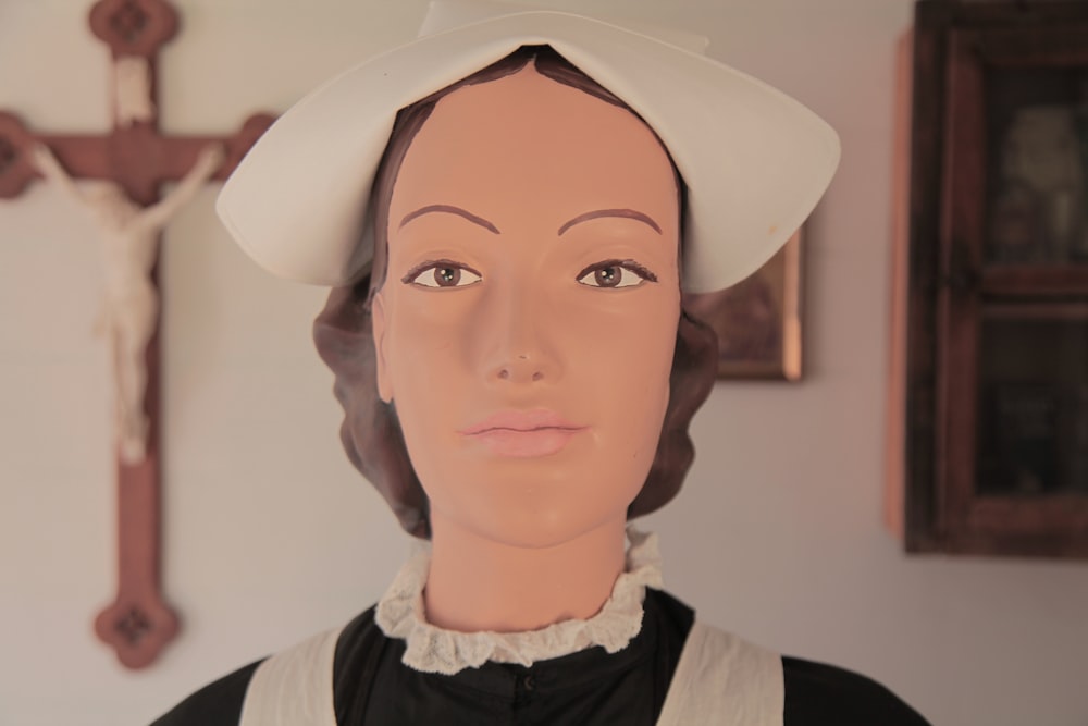 a mannequin wearing a white hat and black dress