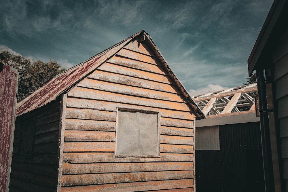 an old wooden building with a broken window