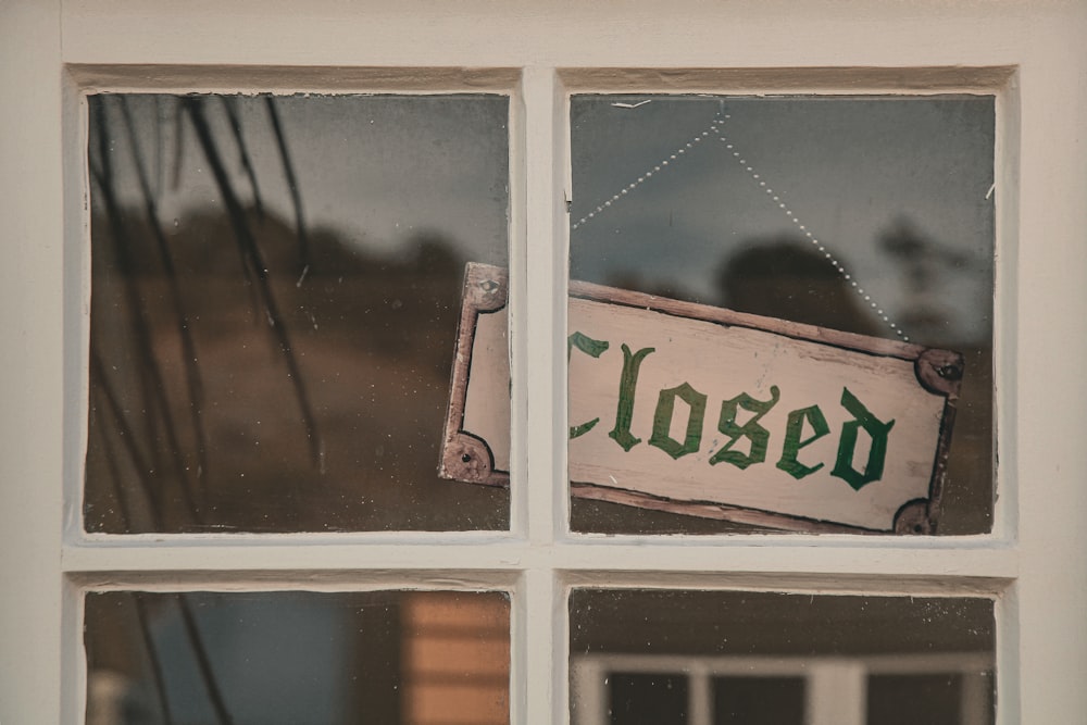 a closed sign is hanging on a window