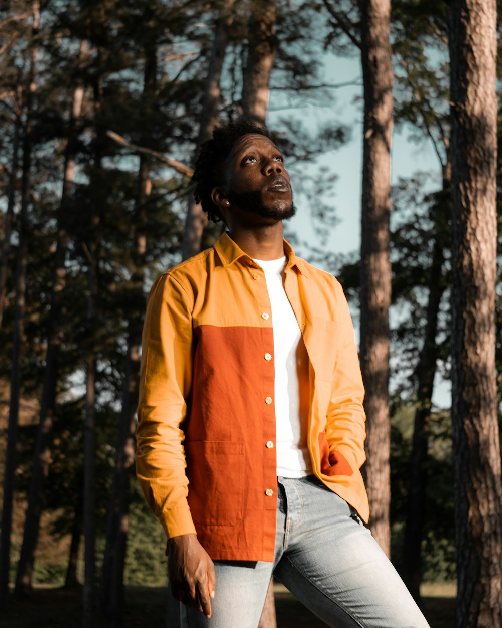 a man standing in front of some trees