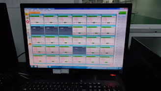 A computer screen displaying compliance checklists and vendor management software dashboards.
