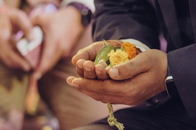 a man in a suit holding a piece of food