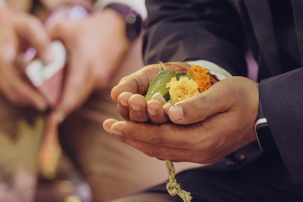 a man in a suit holding a piece of food