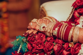 a close up of a bride's hands holding a bouquet of flowers