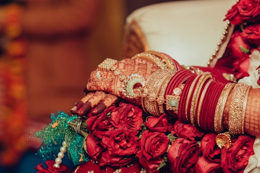 a close up of a bride's hands holding a bouquet of flowers